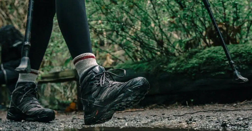pexels-photo-7624977-7624977 Close-up of hiker's boots splashing through a puddle on a forest trail.