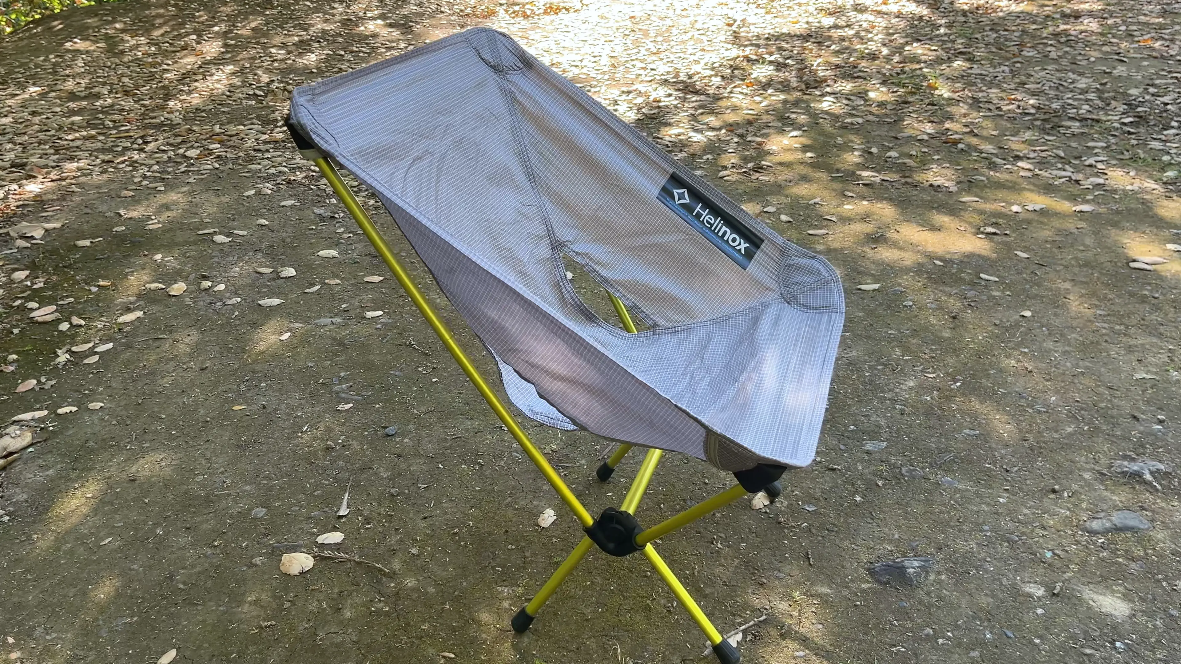 chair-zero-backpacking-chair Helinox Chair Zero ultralight backpacking chair with yellow frame set up on a forest trail