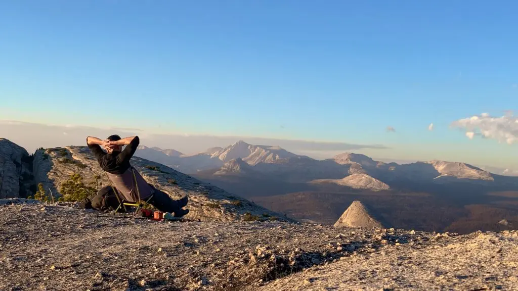 backpacker-sitting-in-chair-zero a backpacker relaxing in the chair zero backpacking chair on a mountain top enjoying the scenes