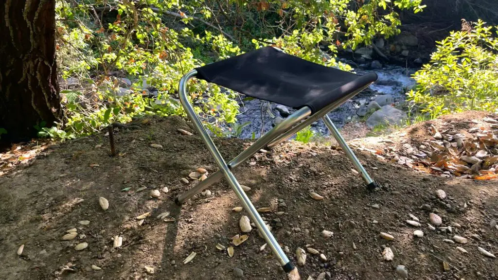 stansport-folding-camp-stool Stansport folding camp stool placed on a trail during a backpacking trip
