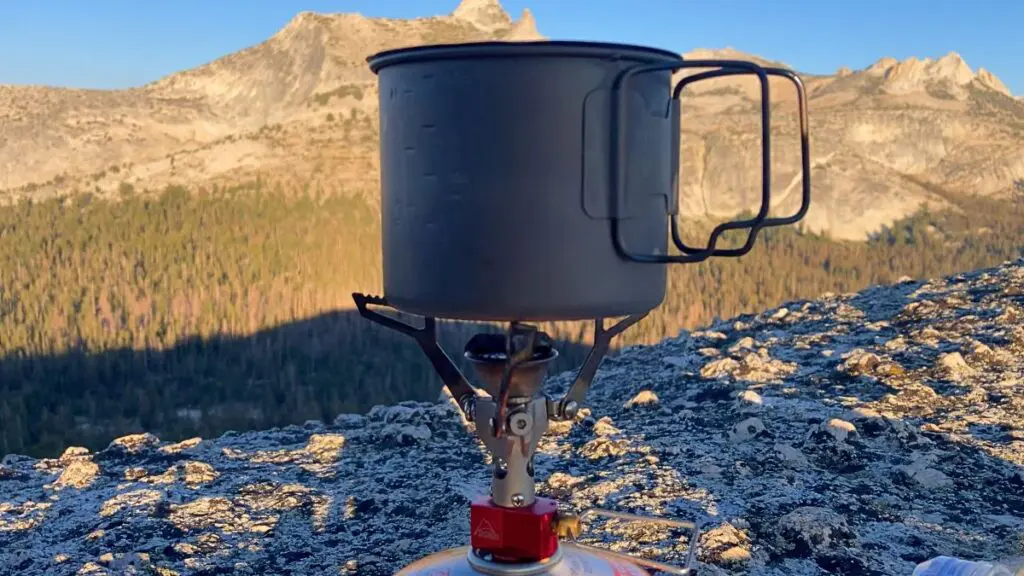 backpacking-stove-on-high-sierra-ridge Backpacking stove and titanium pot on a granite High Sierra ridge at sunset.