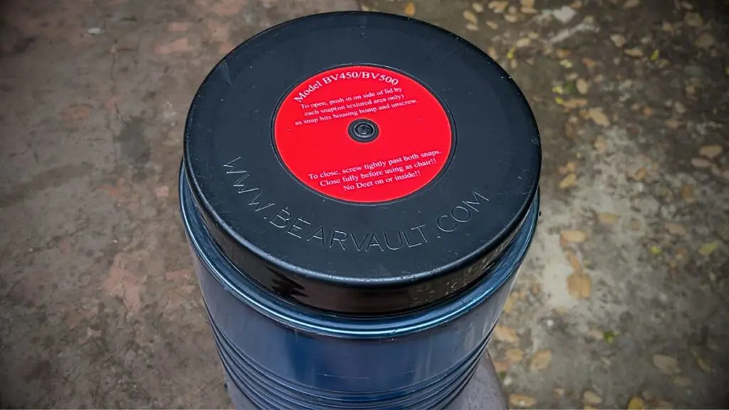 backpacking-bear-canister-bear-vault-500 Top-down view of a BearVault BV500 lid showing the BV450/BV500 instruction label